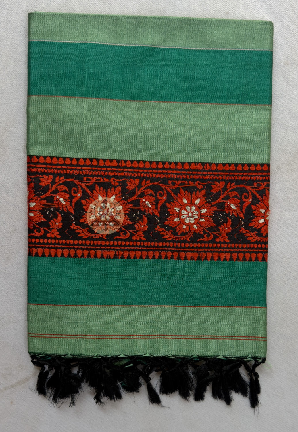 Close-up of terminal panel of Bishnupur Baluchari silk legacy stole showing dense Bankura master weaver narrative motif detail preserved across decades of wear