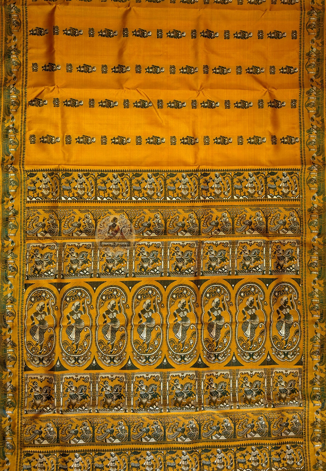 Complete flat lay of mustard Baluchari silk saree showing the body butidar motifs, decorative borders and richly woven pallu with narrative scenes
