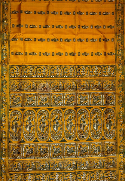 Complete flat lay of mustard Baluchari silk saree showing the body butidar motifs, decorative borders and richly woven pallu with narrative scenes