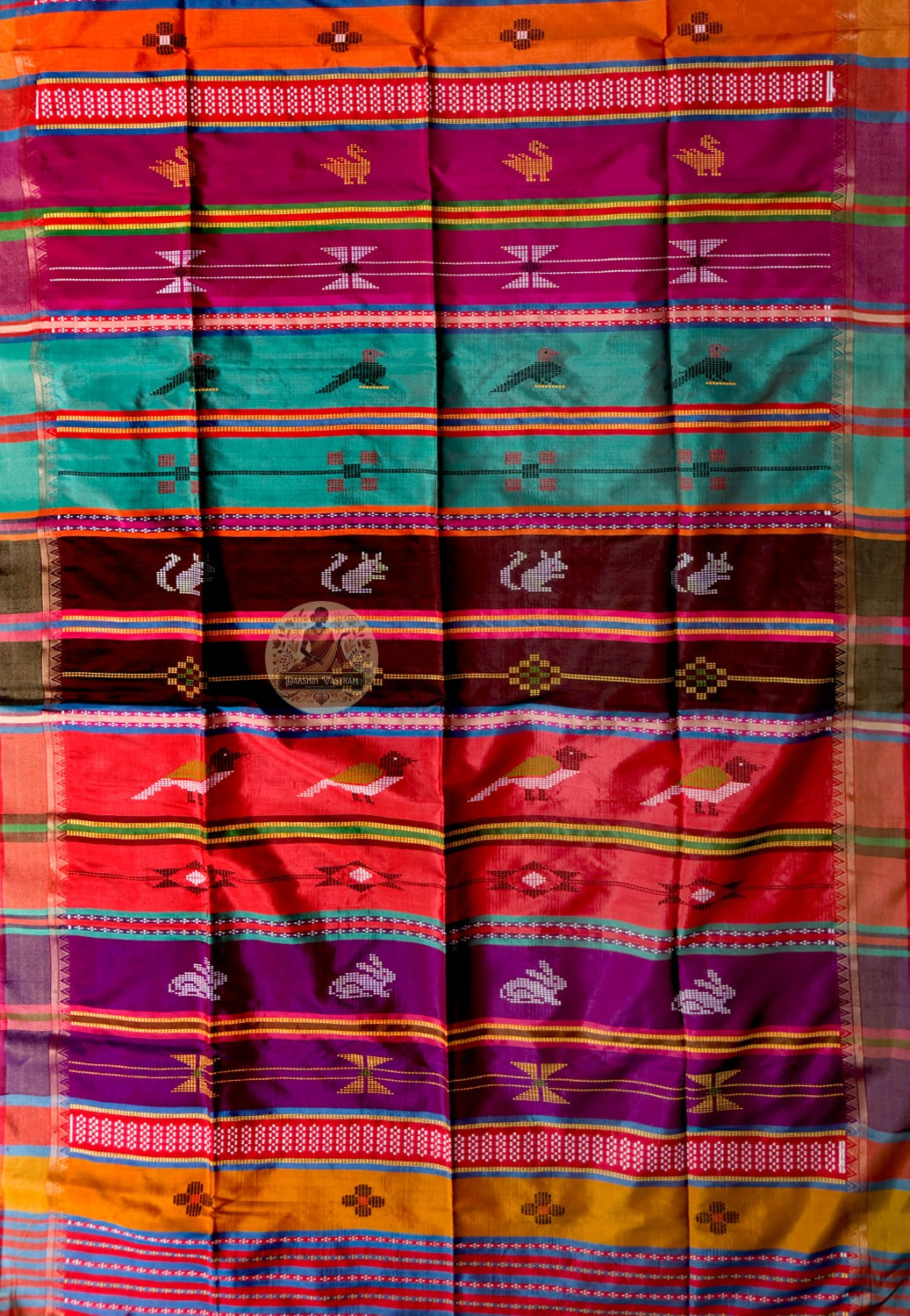 Close-up of Bishnupur Katan silk collector's saree weave showing traditional Bengal buti motifs and structured pure silk surface formed directly in the handloom weave