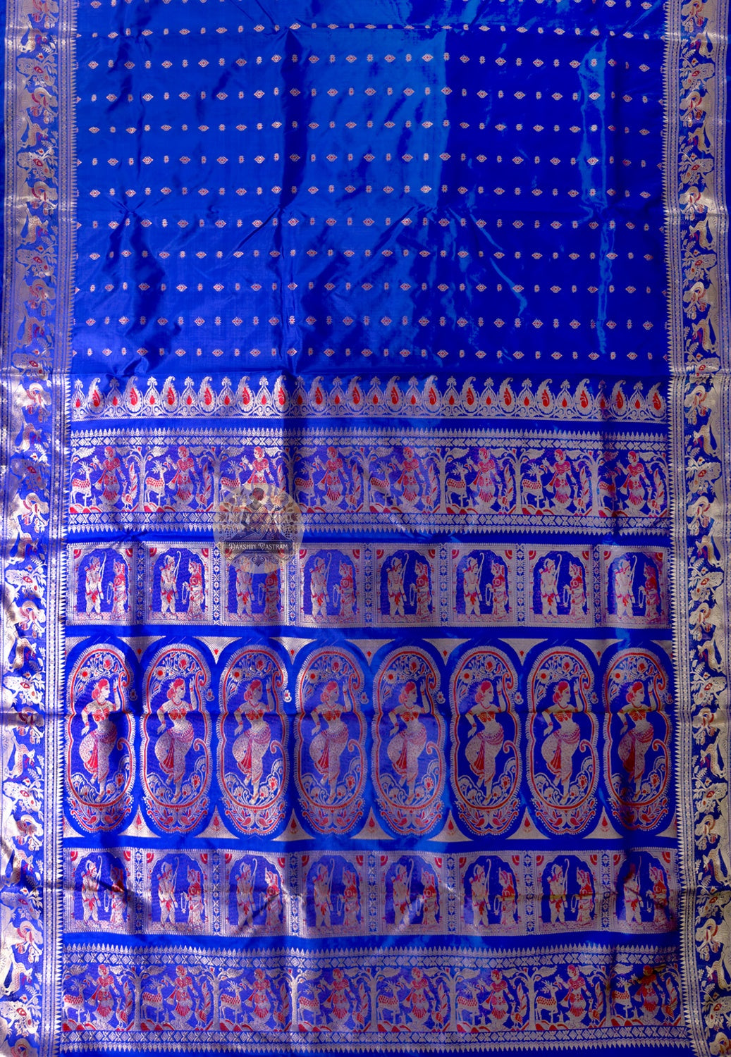 Side view of Bishnupur royal blue Swarnachari handloom silk saree displaying bold drape and gold zari glow against deep blue silk