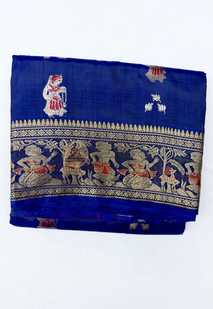 Close up of pink and gold-toned woven motifs on the royal blue Swarnachari silk saree body
