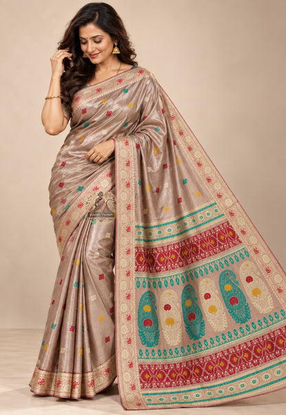 Side view of beige Baluchari silk saree showing the drape and pale circular border details
