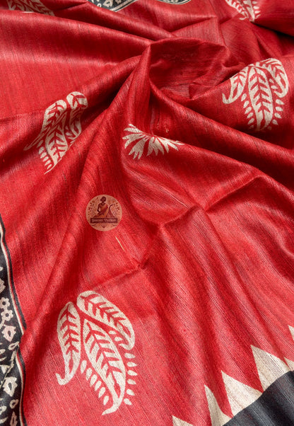 Close up of pale floral rosettes on the red Ghicha Tussar silk saree body