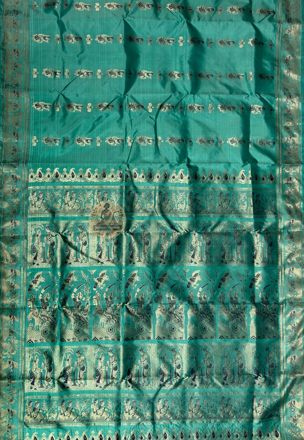 Close-up of golden zari Draupadi vastraharana divine feminine protection scene woven into pallu teal green Swarnachari Bishnupur craft