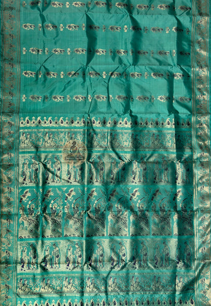 Close-up of golden zari Draupadi vastraharana divine feminine protection scene woven into pallu teal green Swarnachari Bishnupur craft