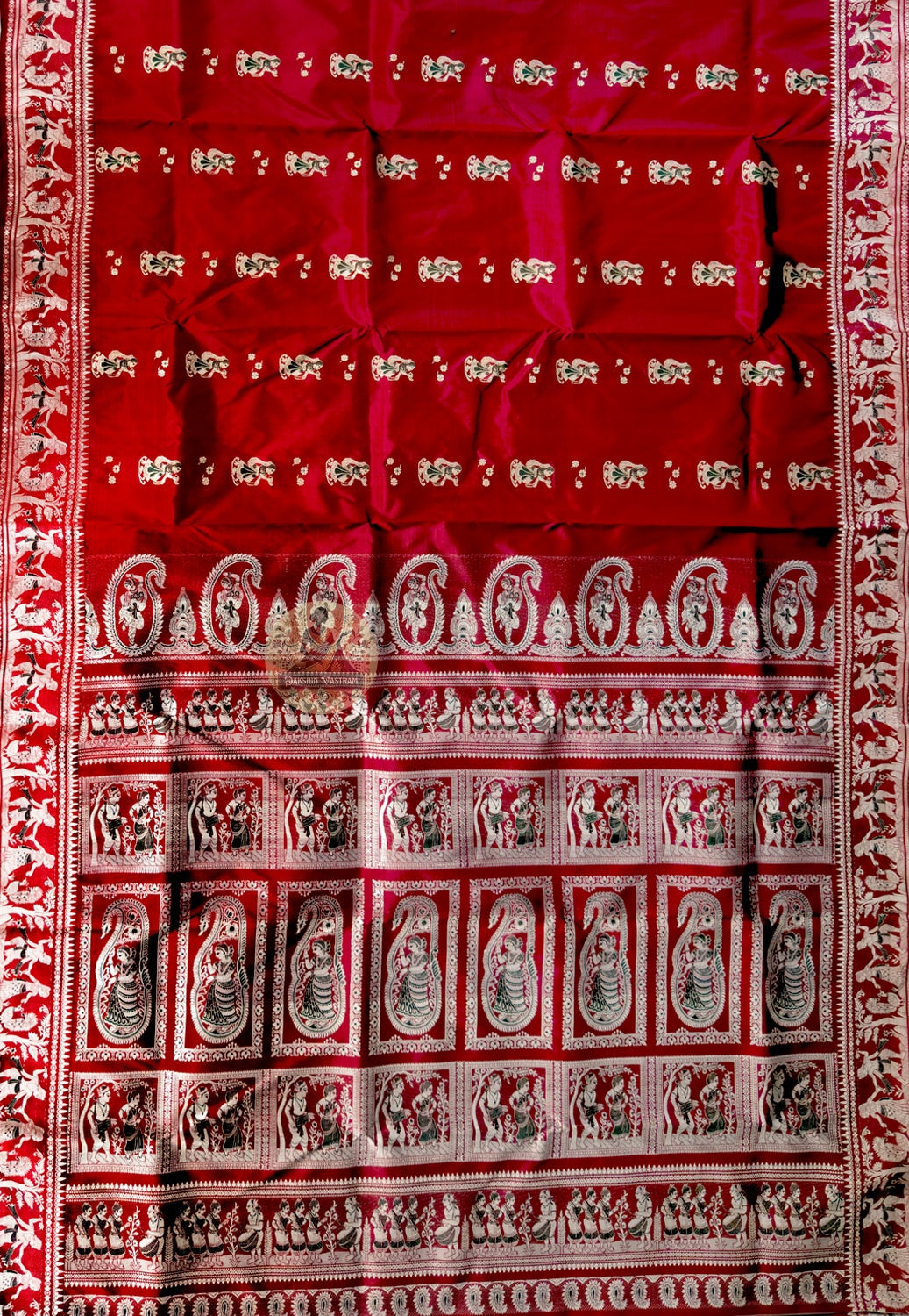 Close-up of Bishnupur maroon Baluchari silk saree weave revealing finely woven mythological figures and floral border on deep maroon silk