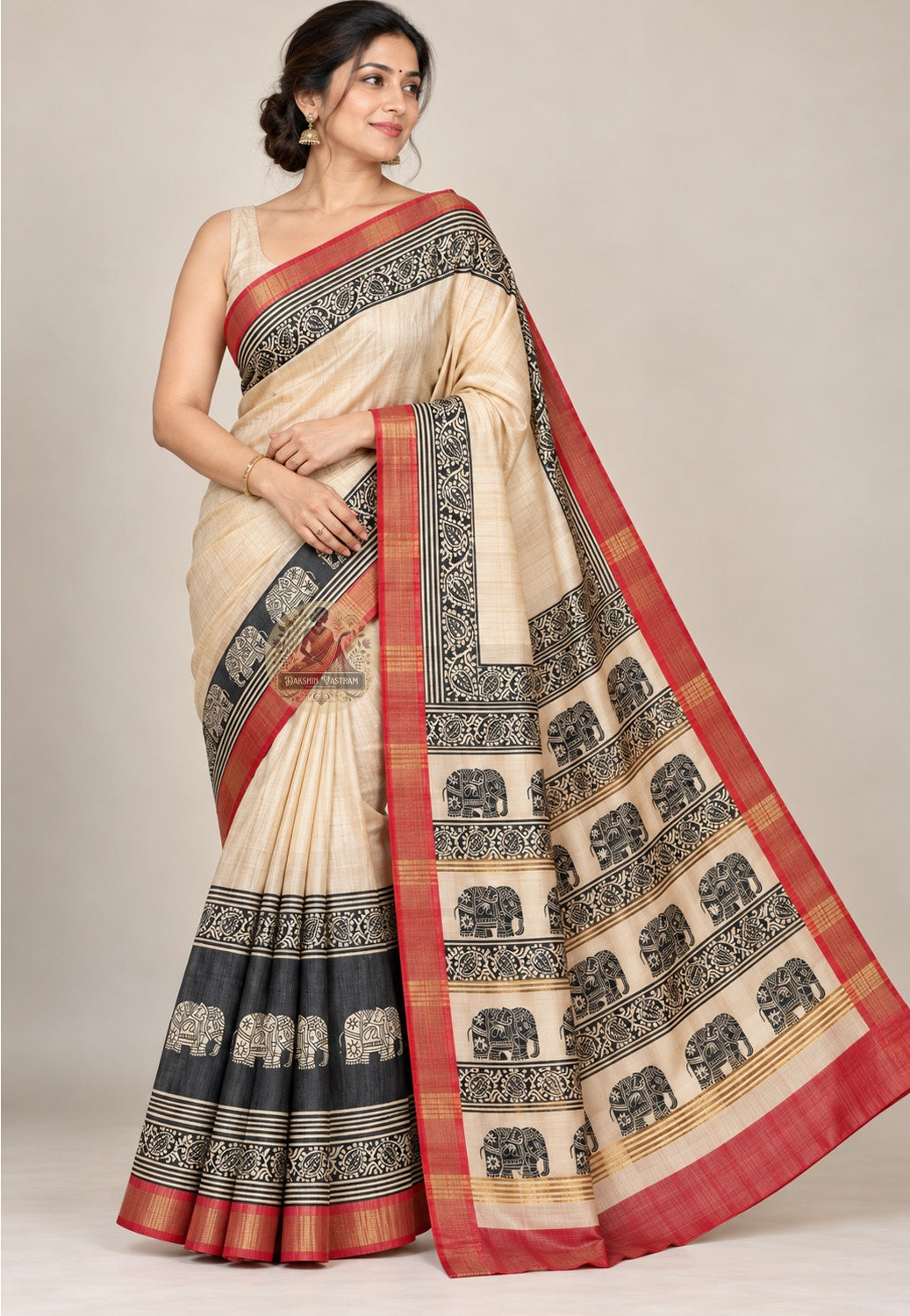 Front view of cream Ghicha Tussar silk saree with black ornamental borders, elephant motifs and red edges