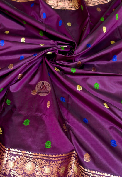 Close-up of premium Swarnachari handloom silk saree body showing naturally lustrous pure silk ground with fine golden zari butis (small woven motifs) creating quiet luminosity across the field, Bengal craft