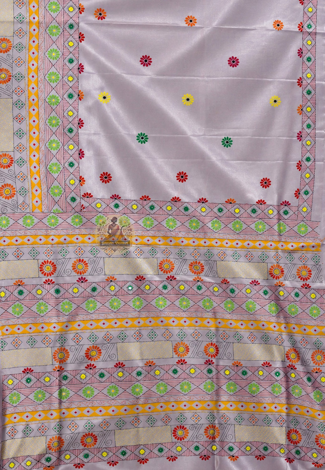 Close-up of kantha stitch Radha Krishna under kadamba tree devotional border on deep saffron Bishnupur silk saree Bankura West Bengal