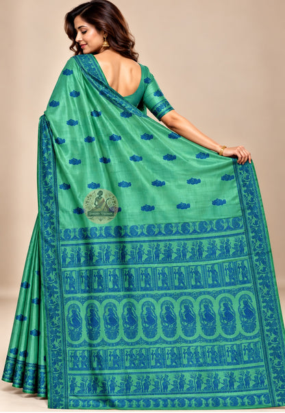 Side view of green Baluchari silk saree showing lustrous folds and a blue patterned border