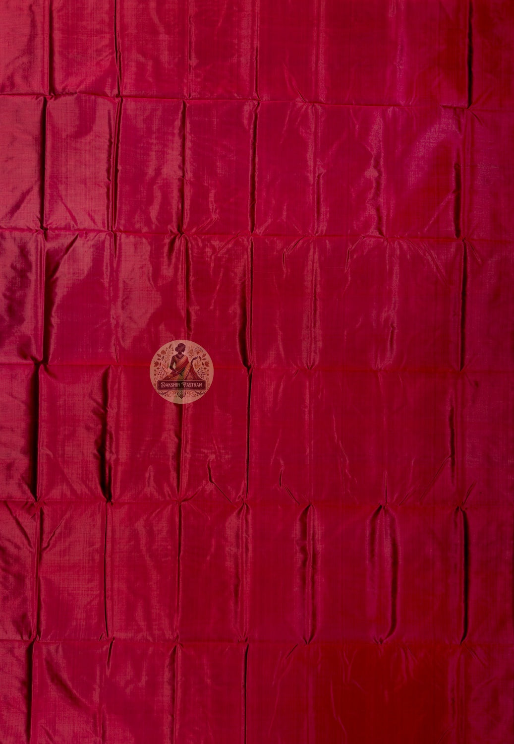 Close up of red Bishnupur silk fabric showing its sheen and subtle surface texture