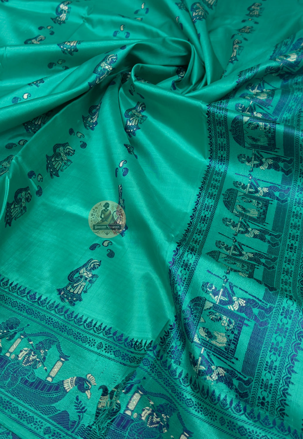 Close up of green Baluchari silk saree pallu with figurative panels and large paisley motifs