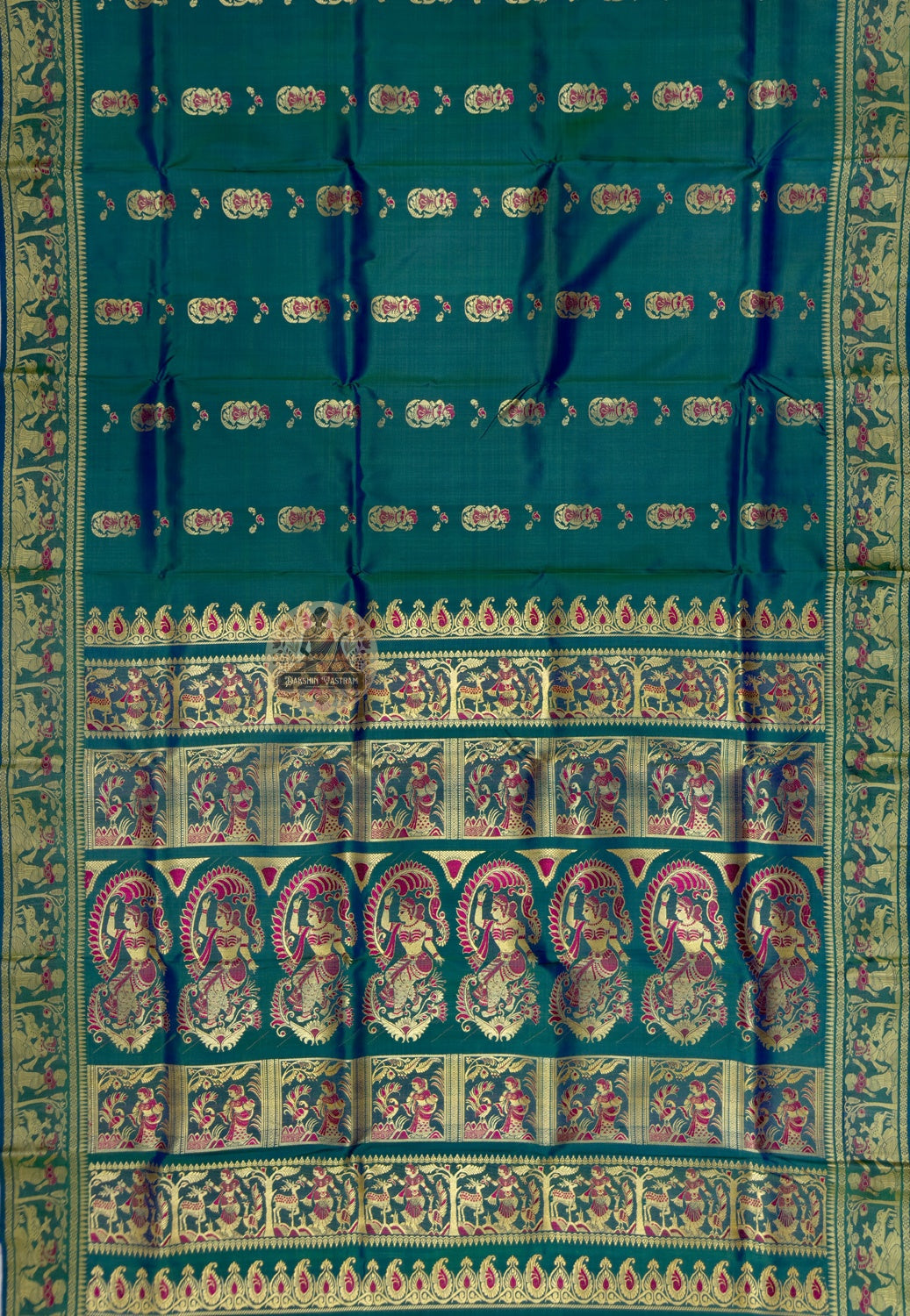 Close up of red-and-pale ornamental motifs and tiny decorative accents on peacock-green silk