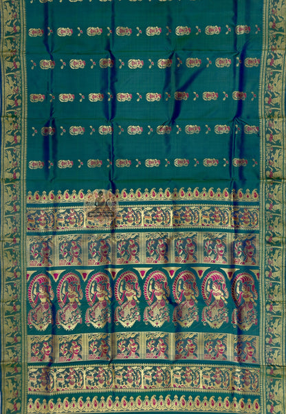 Close up of red-and-pale ornamental motifs and tiny decorative accents on peacock-green silk