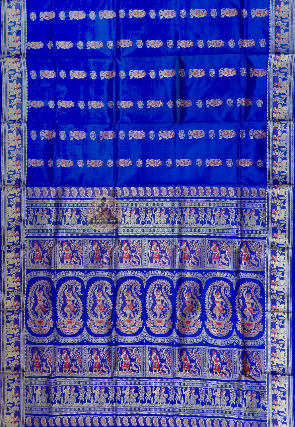 Full saree view of royal blue Baluchari silk saree with repeating motifs and an elaborate pallu