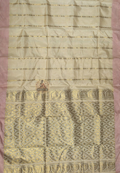 Close-up of kantha stitch temple spire rath geometry and marigold garland detail on natural amber Ghicha Tussar Saree Bengal handloom