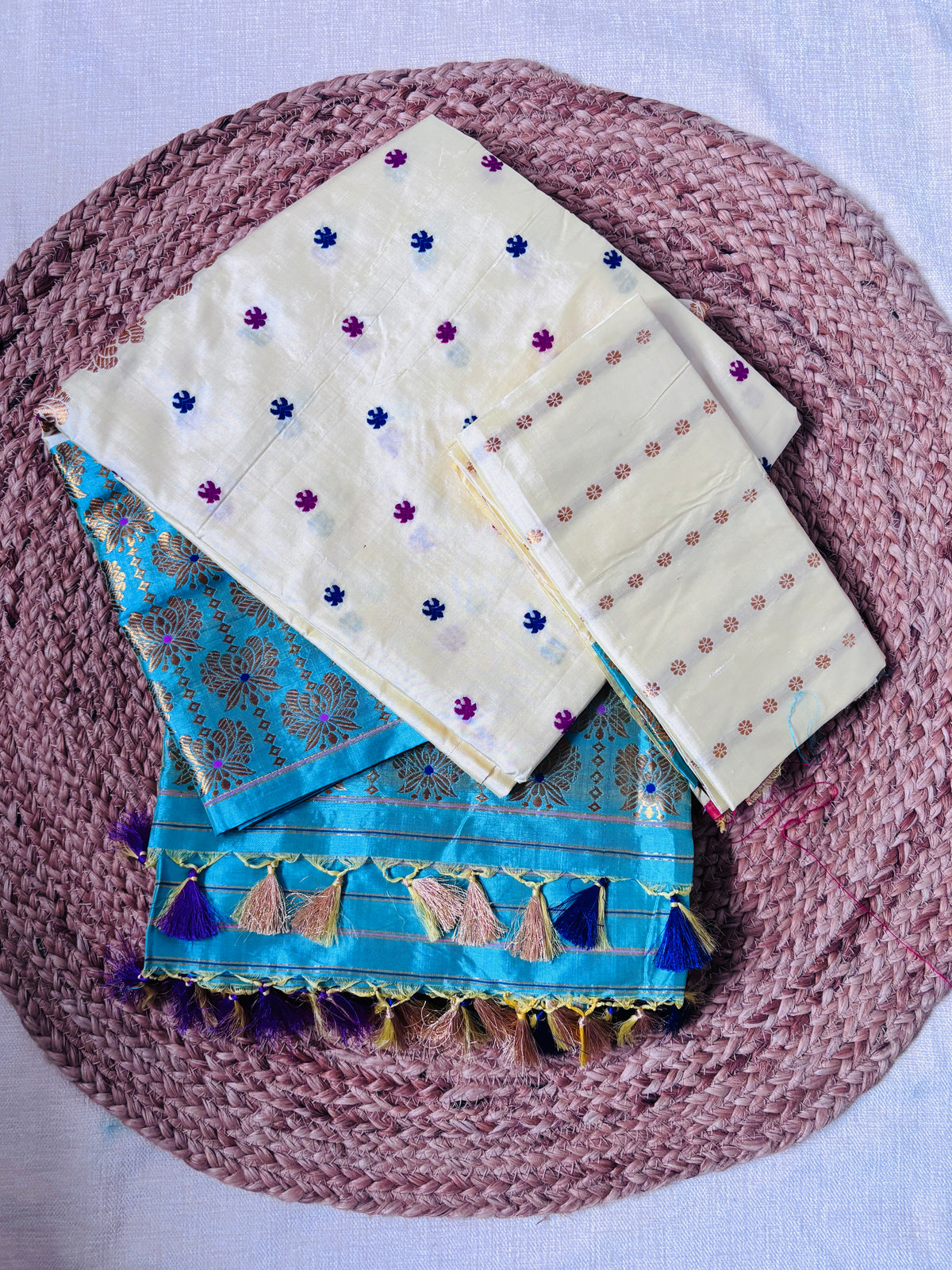 Rear view of Paat Mekhela Chador displaying chador drape with fish mas bamboo border and indigo stripe body Sualkuchi Assam handloom