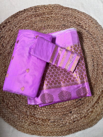Front view of woman wearing Paat Mekhela Chador with ivory silk blouse Assamese bridal reception first entry authentic Sualkuchi Assam silk