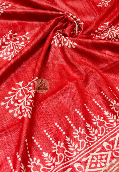Close up of pale floral clusters on the red Ghicha Tussar silk saree body