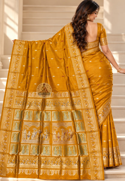 Rear view of mustard-gold Swarnachari silk saree with the figurative pallu draped over the shoulder