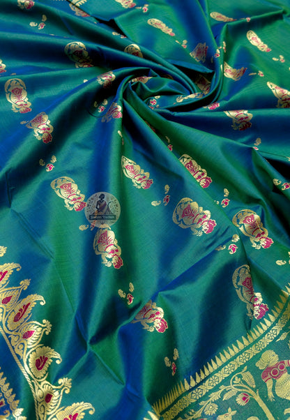 Rear view of peacock-green Baluchari silk saree showing the decorative pallu over the shoulder