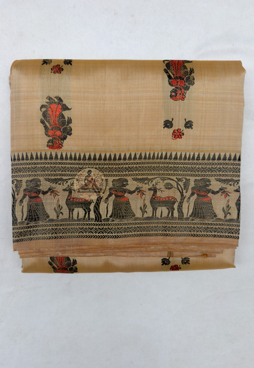 Close up of small red motifs with dark outlines on the beige Baluchari silk saree body