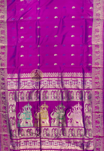 Close up of magenta Swarnachari silk saree pallu with figurative scenes and rows of woven figures