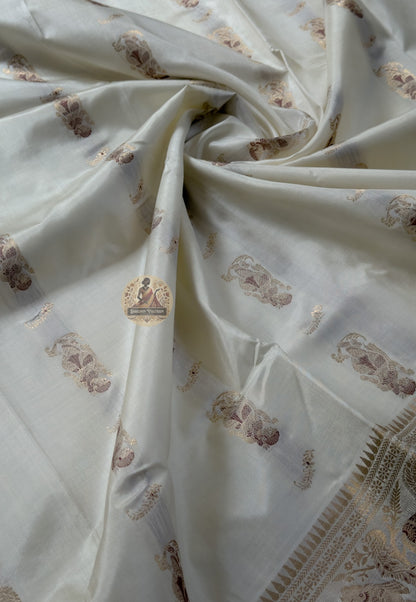 Rear view of white Swarnachari silk saree showcasing fully expressed pallu with mythology and Bishnupur temple art golden zari compositions at full clarity on pure white silk ground
