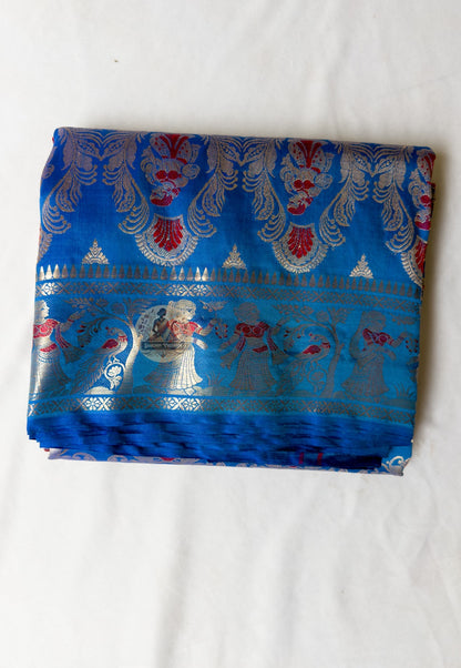 Close-up of blue Swarnachari silk saree weave showing golden zari mythology figures Malla court motifs and Bishnupur temple art patterns in sharp relief on bright blue silk ground