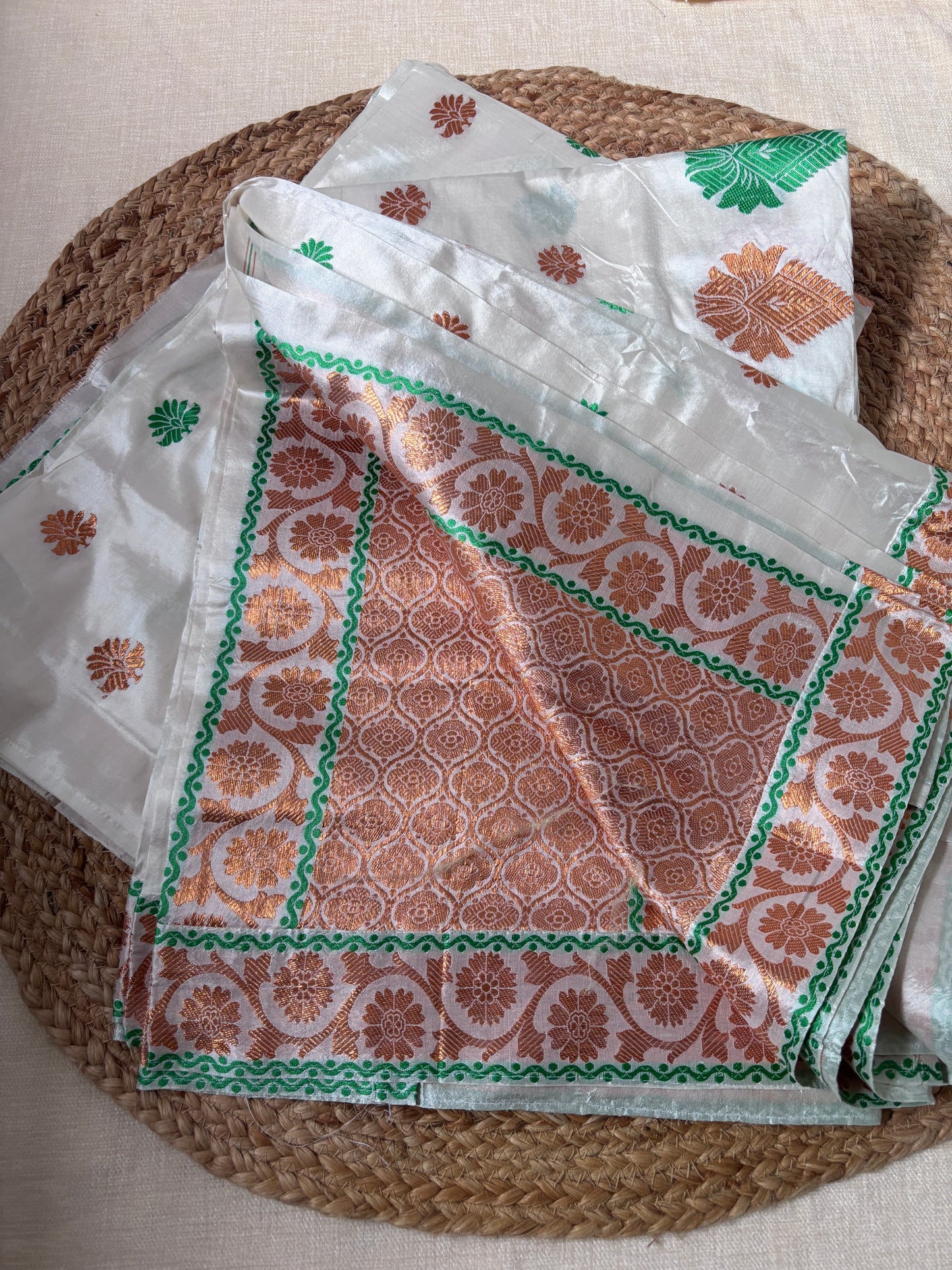 Rear view of Paat Mekhela Chador displaying chador drape with elephant procession border and temple vine field Sualkuchi Assam handloom