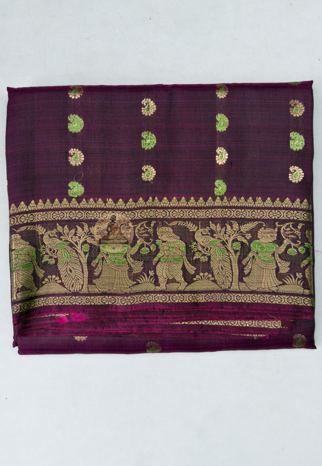 Close-up of hand-woven golden zari motif on Swarnachari silk saree pallu, depicting Mahabharata-inspired courtly scene, West Bengal handloom