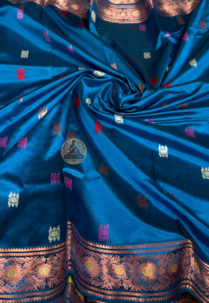 Rear view of premium Swarnachari silk saree displaying golden zari pallu with hand-woven patiently resolved Bengal temple sculpture and Ramayana narrative compositions