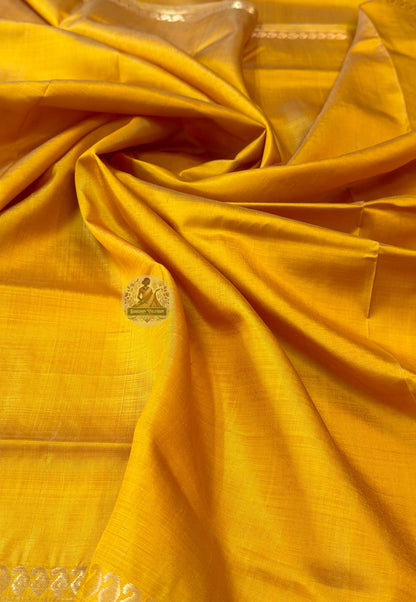 Close-up of Bishnupur Katan silk pallu with hand-woven heritage motifs placed with the care of a weaver who knows this saree will travel far from where it was made and needs to carry something of Bishnupur with it