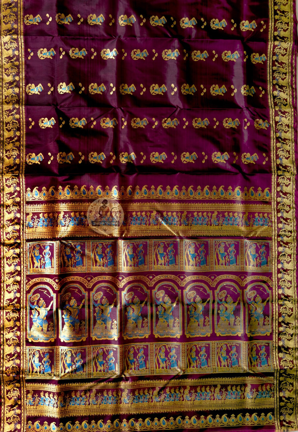 Side view of coffee Baluchari pure silk saree displaying natural fluid mulberry silk drape and coloured silk narrative motifs warming against coffee ground for classical and cultural occasions