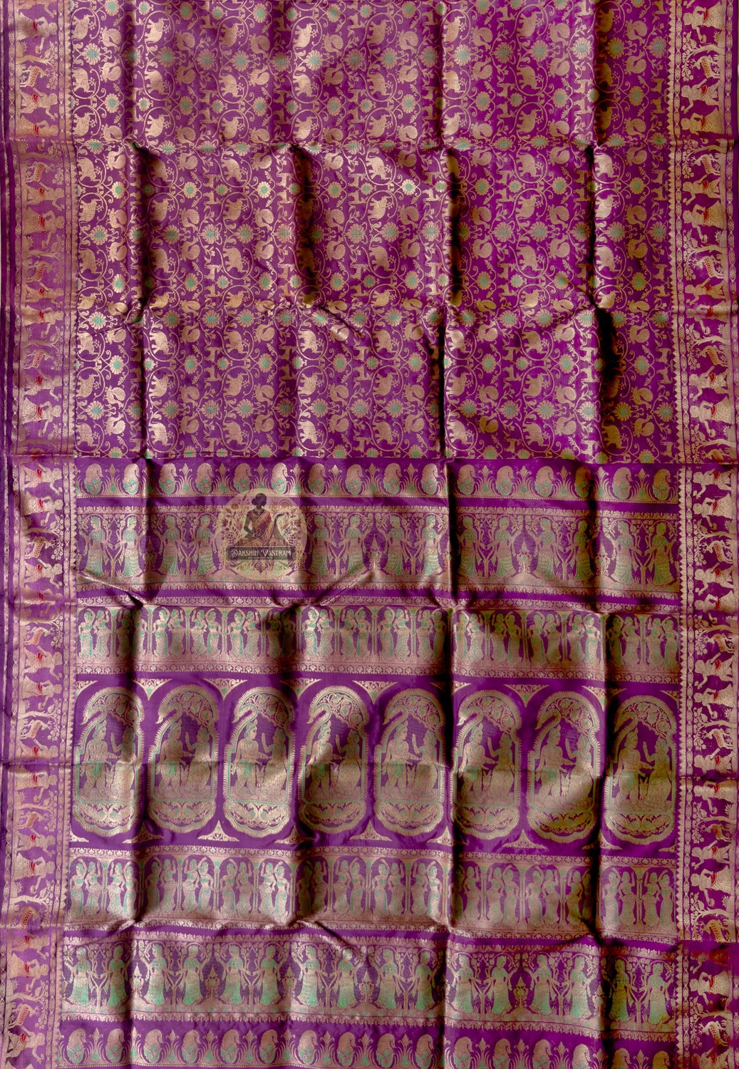 Close-up of premium Swarnachari handloom silk saree body showing warm pure silk ground with precisely drawn golden zari butis (small woven motifs) spaced with narrative intention, West Bengal craft