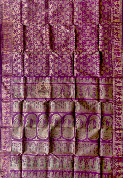 Close-up of premium Swarnachari handloom silk saree body showing warm pure silk ground with precisely drawn golden zari butis (small woven motifs) spaced with narrative intention, West Bengal craft