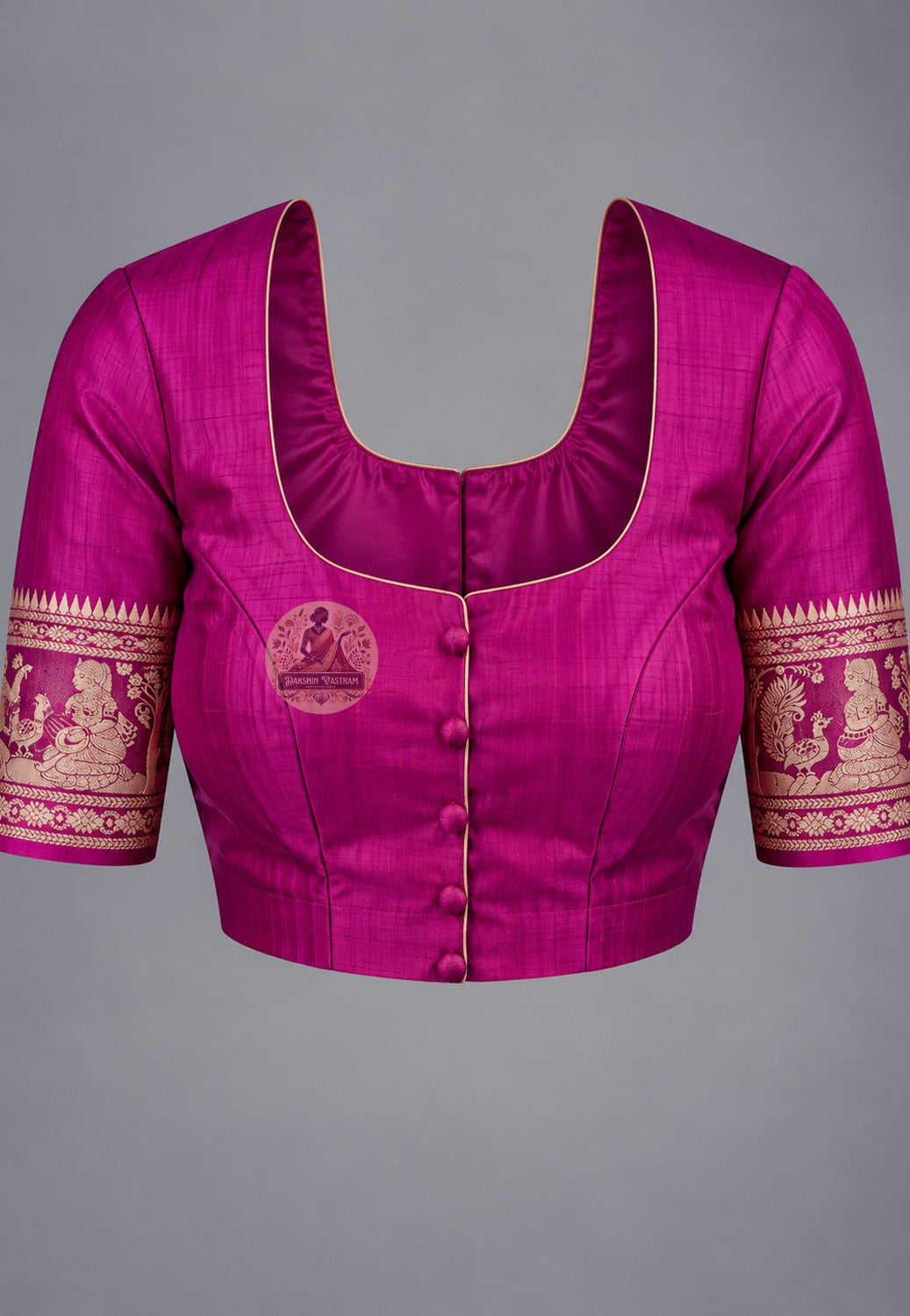 Blouse paired with magenta Swarnachari silk saree, featuring gold-toned patterned sleeve borders