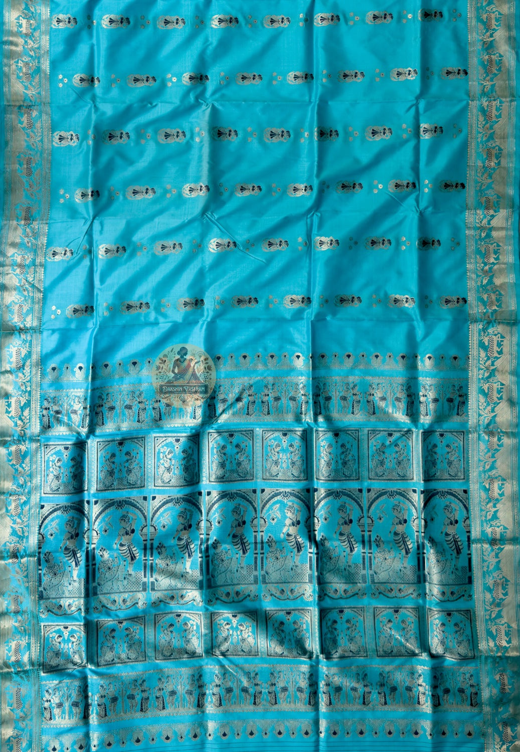 Close-up of Swarnachari silk saree pallu showing hand-woven golden zari panel with Bengal royal court and temple sculpture heritage motifs, West Bengal handloom