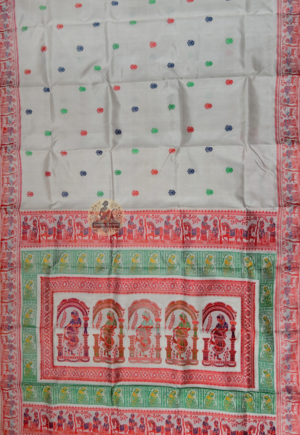 Close up of cream Baluchari silk saree pallu with framed figures and contrasting green bands