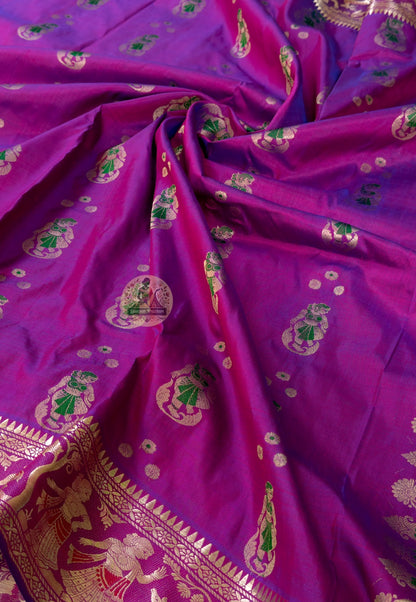 Rear view of purple Swarnachari silk saree showcasing fully expressed pallu with mythology and Bishnupur temple art golden zari compositions deepening in warm pandal and reception light