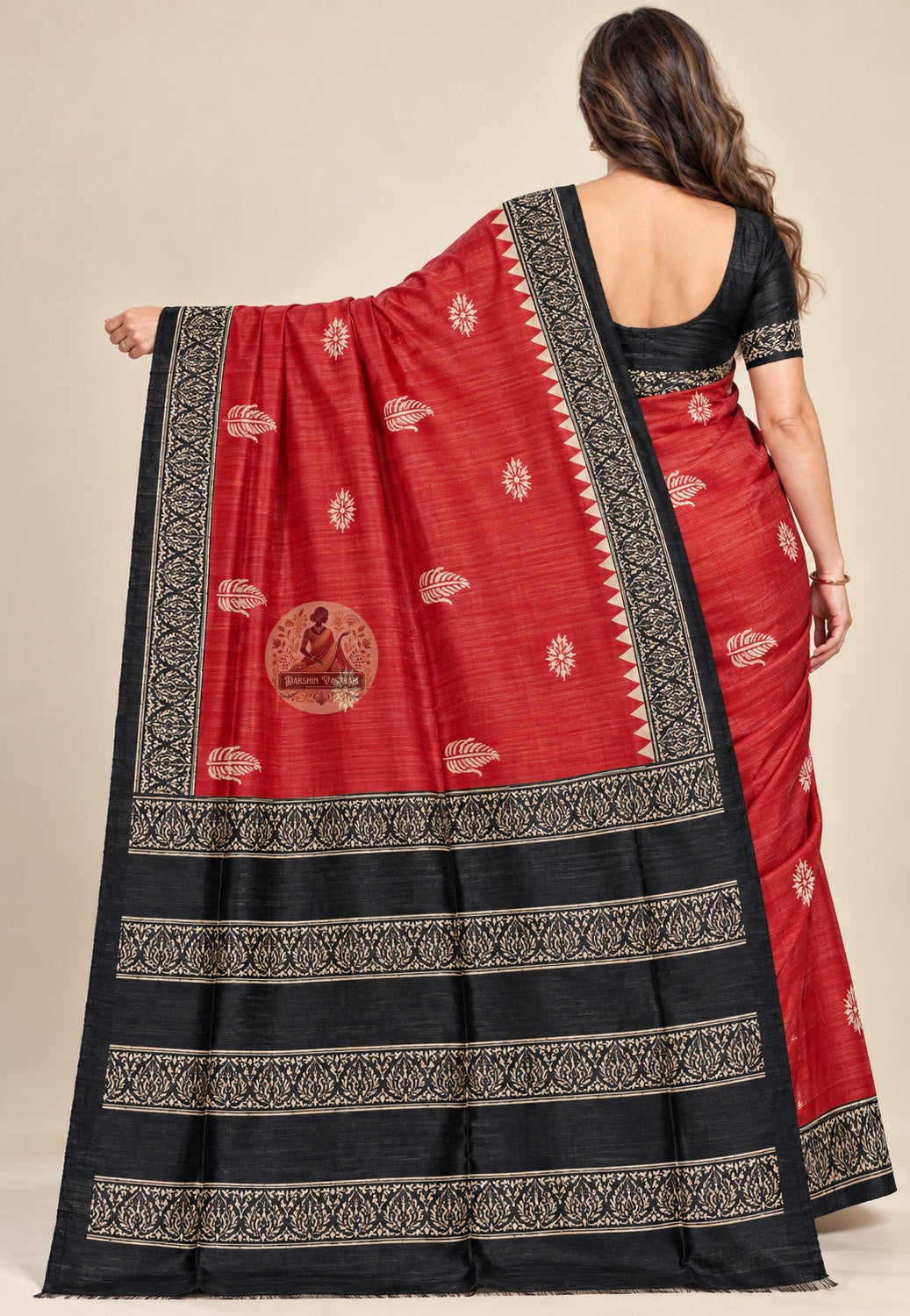 Side view of red Ghicha Tussar silk saree showing the pleated drape and contrasting black border