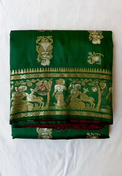 Full flat-lay of Swarnachari pure silk saree with golden zari craft border, Bengal identity narrative pallu, fine buti field, and matching unstitched blouse piece, West Bengal handloom