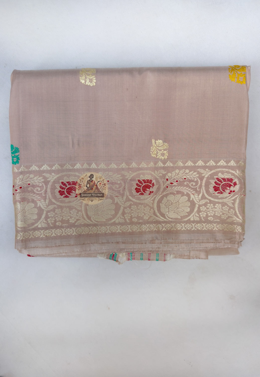 Close up of turquoise, red and yellow motifs on the beige Baluchari silk saree