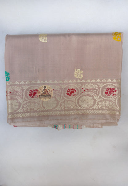 Close up of turquoise, red and yellow motifs on the beige Baluchari silk saree