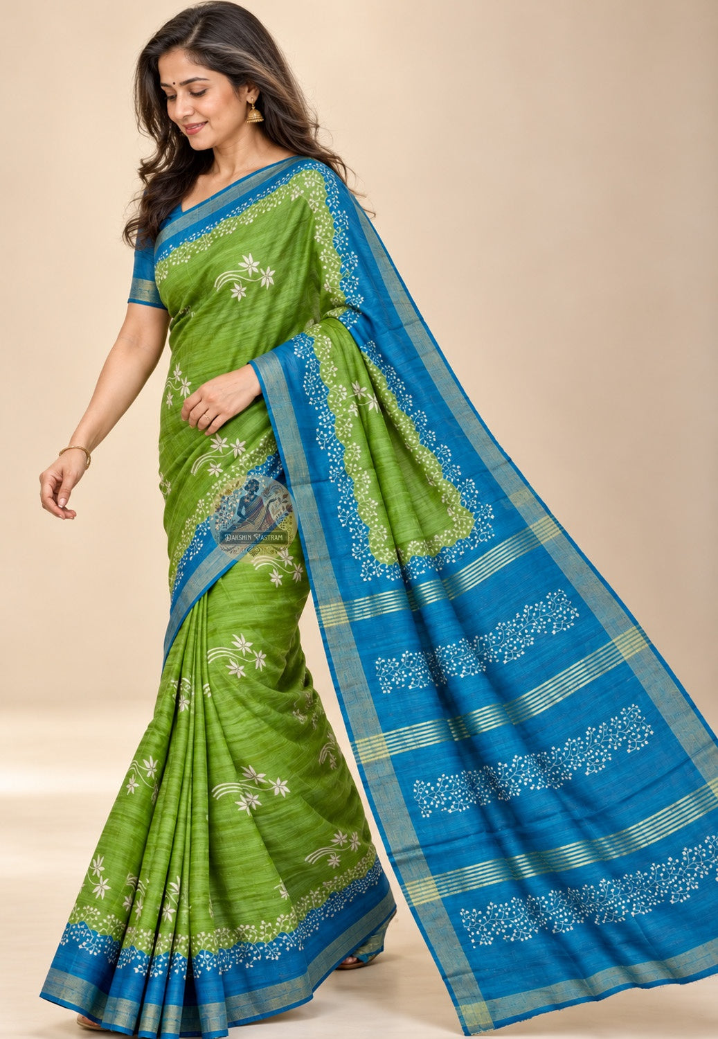 Front view of green Ghicha Tussar silk saree with pale floral sprays and contrasting blue borders