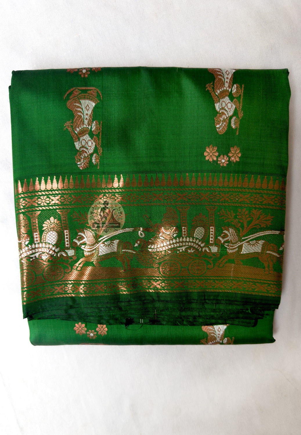 Full flat-lay of Swarnachari pure silk saree with fine golden zari detail border, precisely resolved narrative pallu, depth-rich buti field, and matching unstitched blouse piece, West Bengal handloom