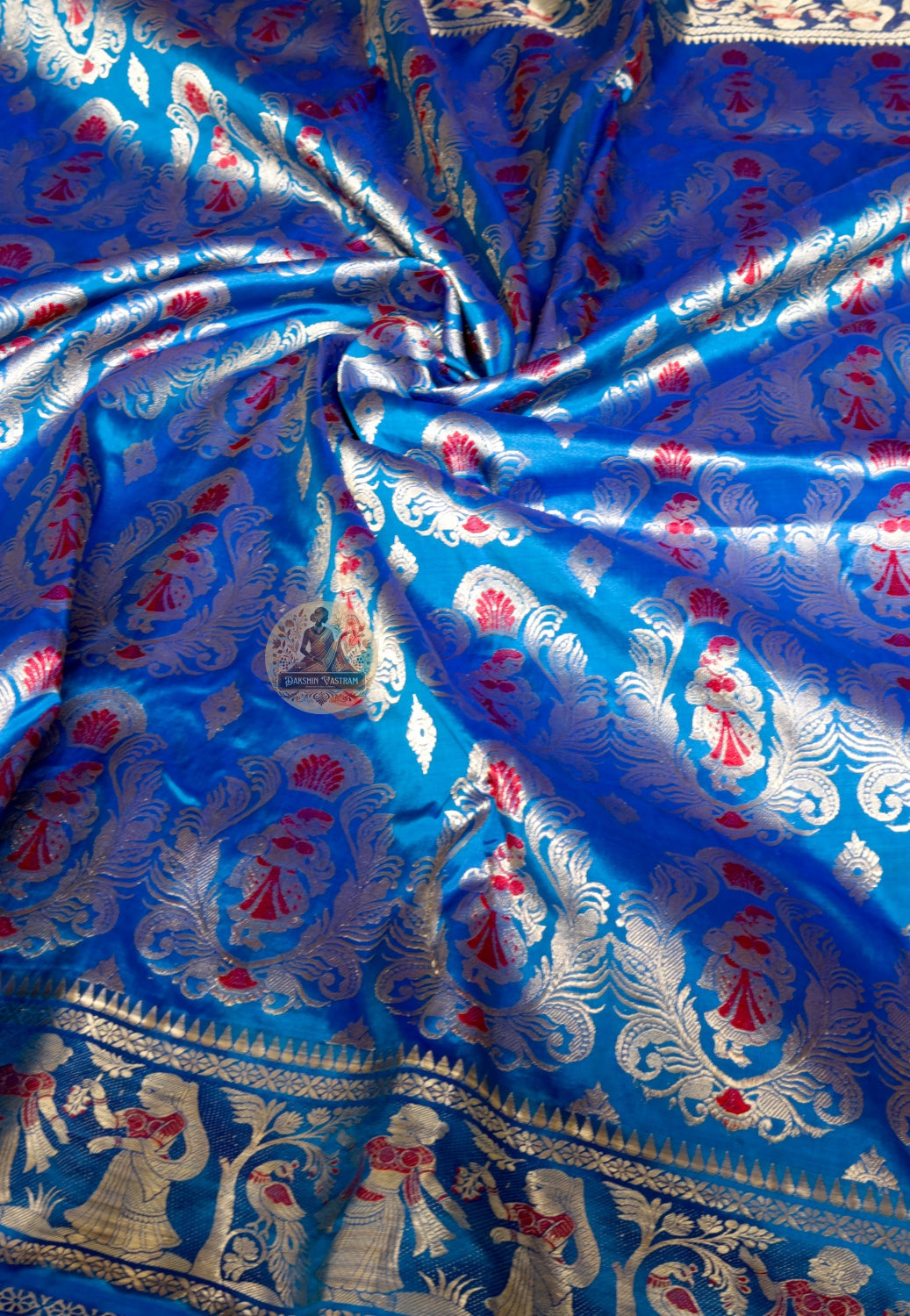 Rear view of blue Swarnachari silk saree showcasing fully expressed pallu with mythology and Bishnupur temple art golden zari compositions reading with clarity on bright blue ground