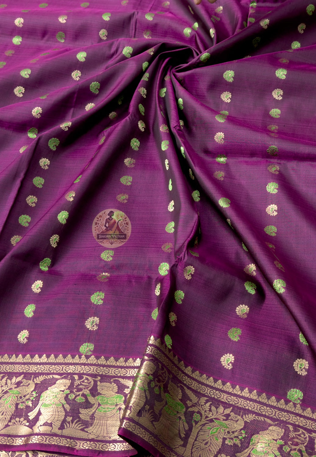 Rear view of Swarnachari silk saree displaying ornate golden zari pallu with courtly and temple-art narrative panels