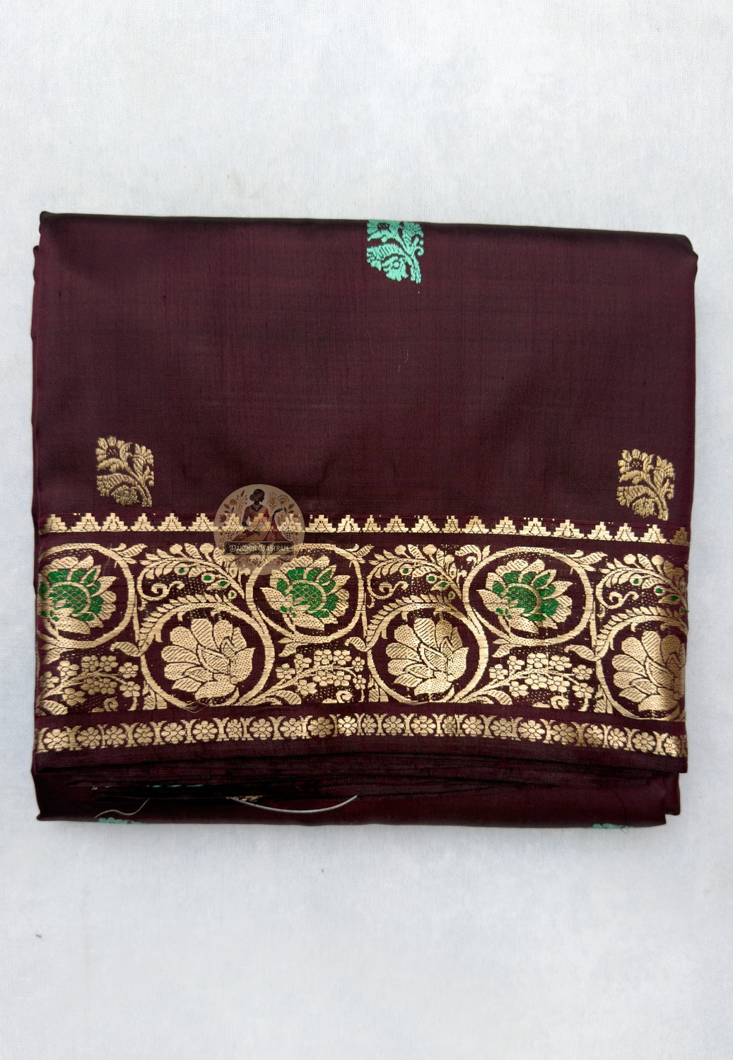 Close-up of Swarnachari silk saree pallu showing hand-woven golden zari dialogue panel with Bengal royal court figures and temple tradition motifs in exchange with the weaver's hand